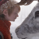 A little boy in a red stocking cap closes his eyes as he meets a reindeer in a scene from Netflix holiday fantasy A Boy Called Christmas.